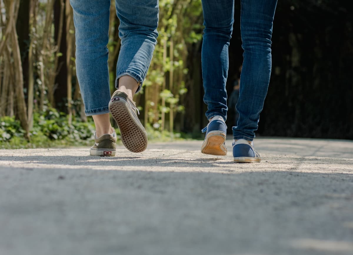 Two people walking together along a street in conversation