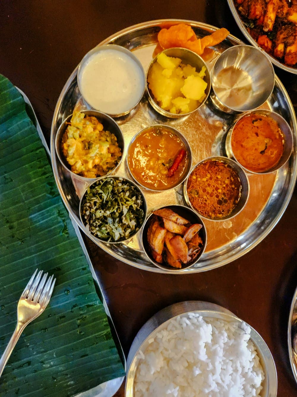 A traditional vegetarian Tamil lunch thali served on a banana leaf
